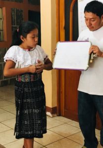 Young Mayan girl works with instructor